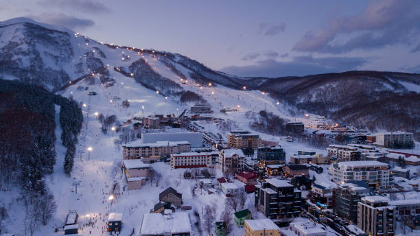 NISEKO, JAPAN - DECEMBER 22, 2017 : Aerial view at dusk of night skiing in Niseko Village. Niseko is a popular destination for ski resorts in Japan